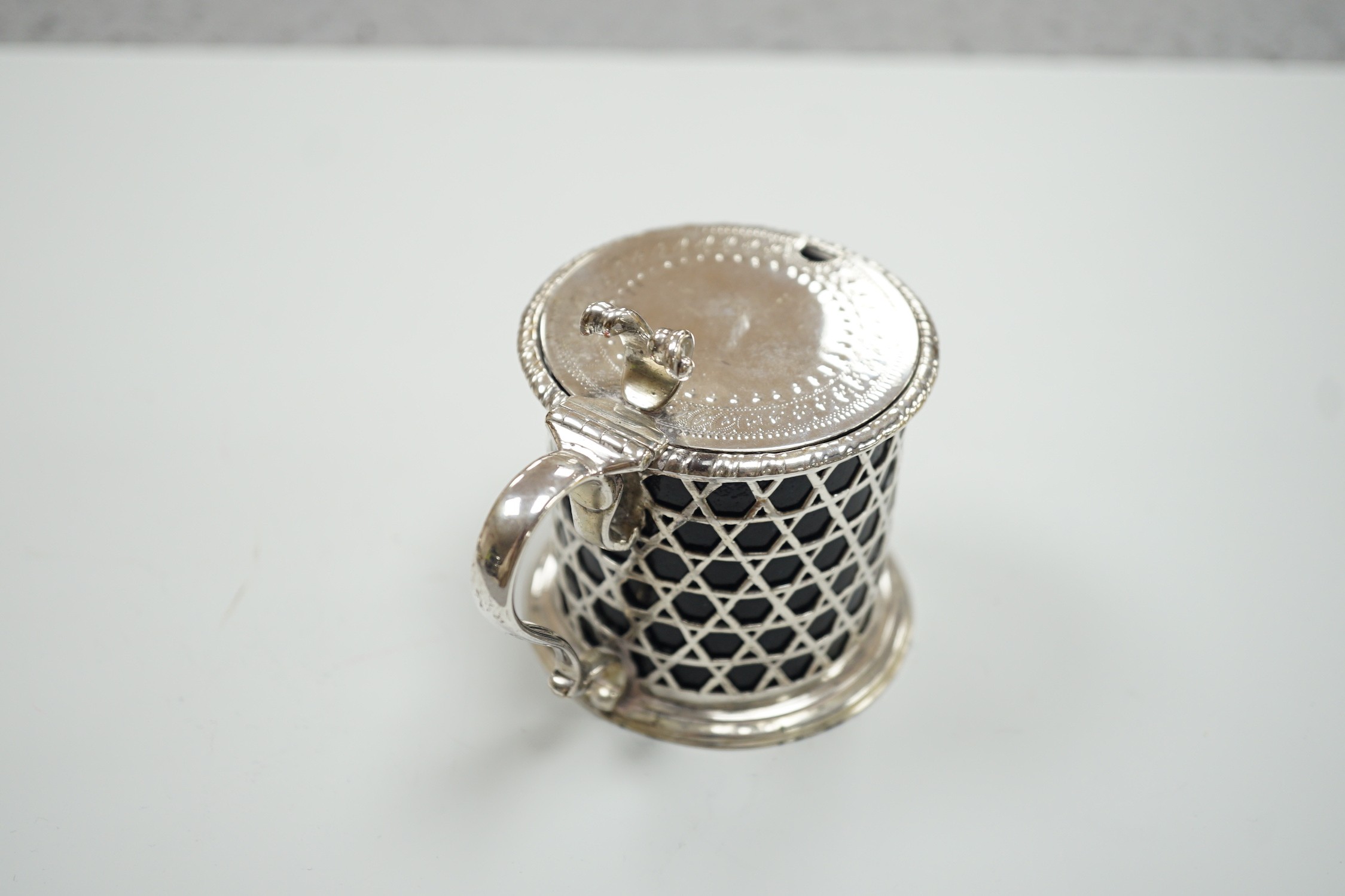 A Victorian pierced silver drum mustard pot by George Fox, London, 1872, with blue glass liner, (handle repair), height 76mm.